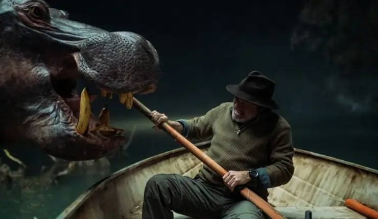 An older man in a hat fights a creature from a boat in Hungry