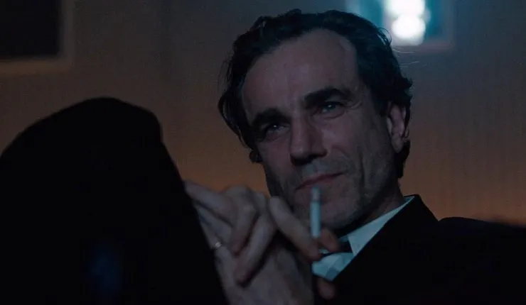A man watches something whilst smoking (Daniel Day Lewis, Nine)