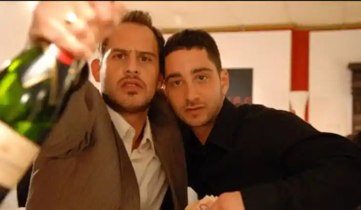 2 men celebrate with a drink in Chiko