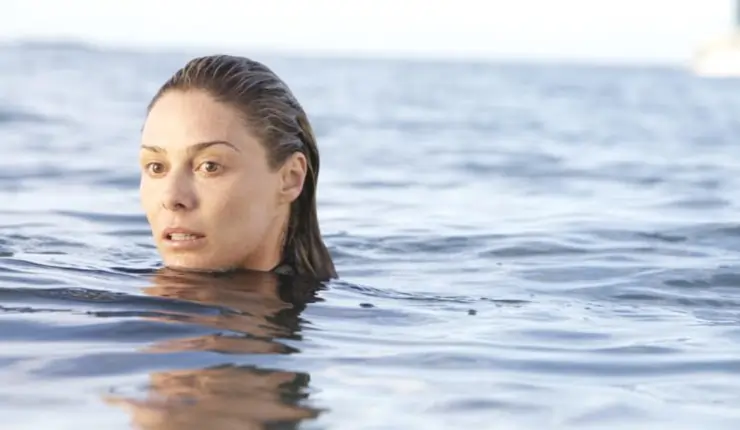 A woman swims with concern in open water