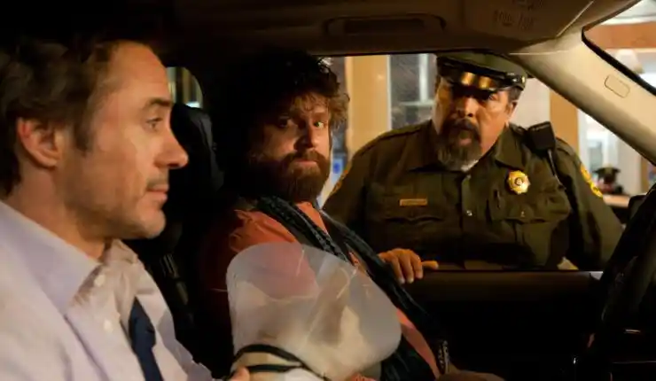 2 men in a car with a dog questioned by a police man