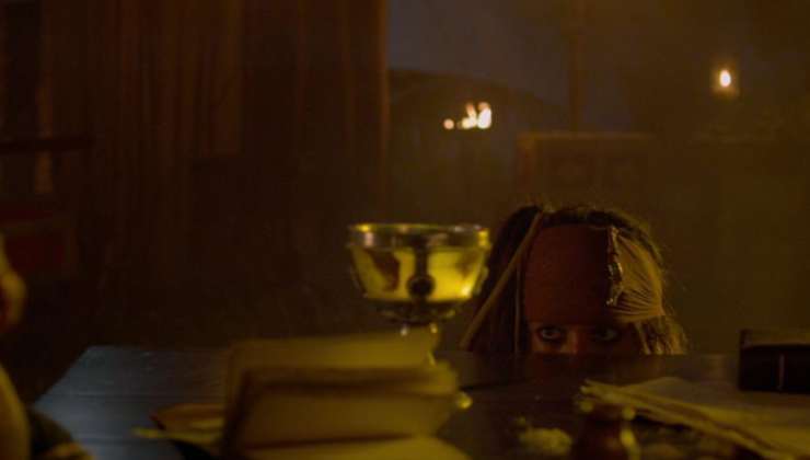 Caotain Jack hiding behind a table in Pirates Of The Caribbean On Stranger Tides