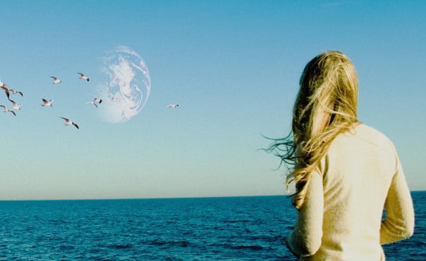 A woman stars into the sea in Another Earth