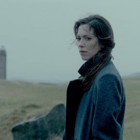 A woman stands on Hillside reflecting or searching for something