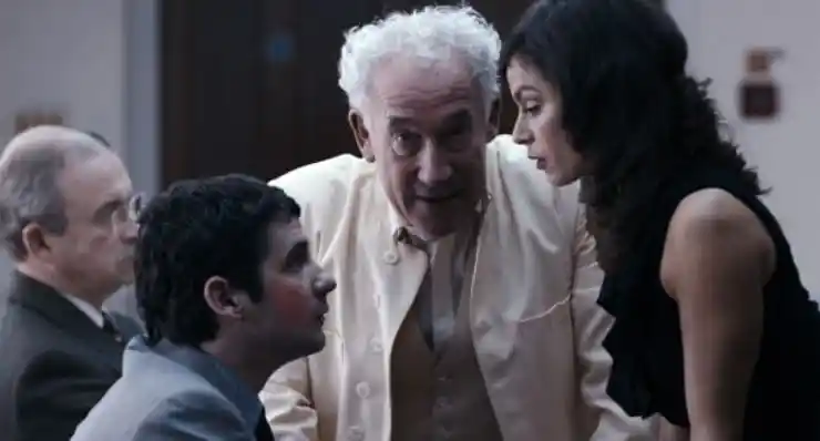 a OLDER MAN IN WHITE WATCHES A YOUNGER COUPLE ARGUE IN aCTS oF gODFREY