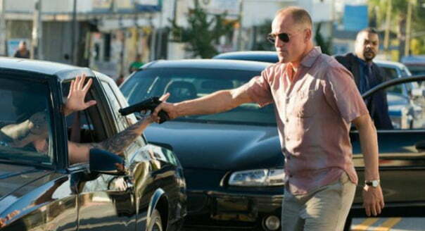 Angry man points a gun at a car