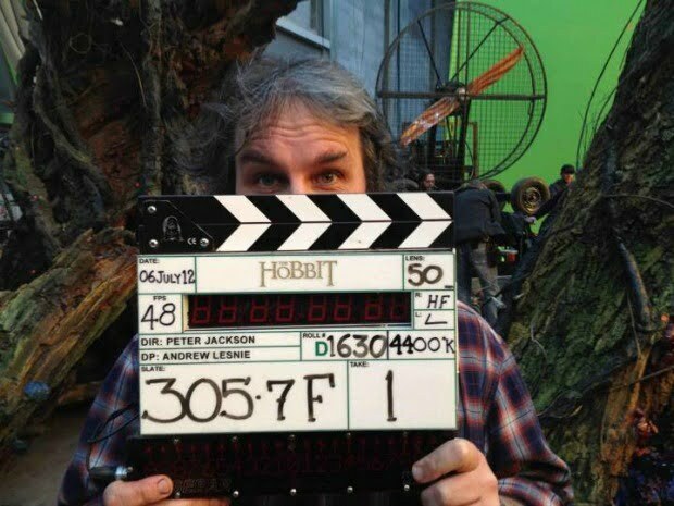 A man (Peter Jackson), with a 'wrap' clapboard for The Hobbit.