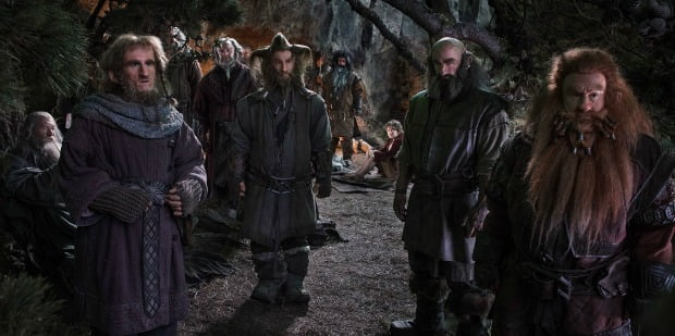 A group of Dwarves together look on at something in The Hobbit