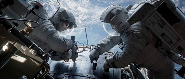 Male and female astronaut repair space station in Gravity