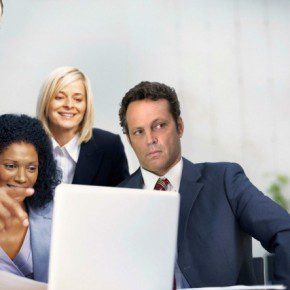 Business man discussing project on laptop with colleagues