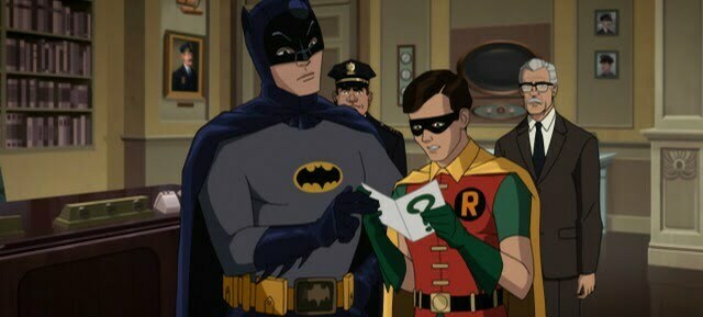 Robin in full cape with Batman checking out clue to a crime