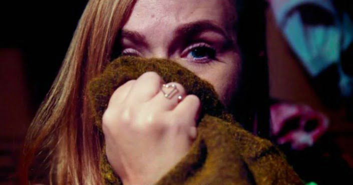 A woman covers her face with a blanket in Fashionista