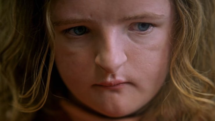 Close up of a young girl looking worried.