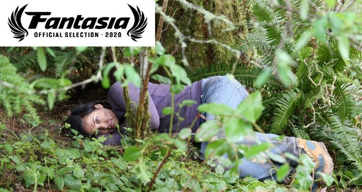 A woman lies in the grass in Alone