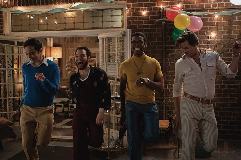 The boys dance together in the boys in the band
