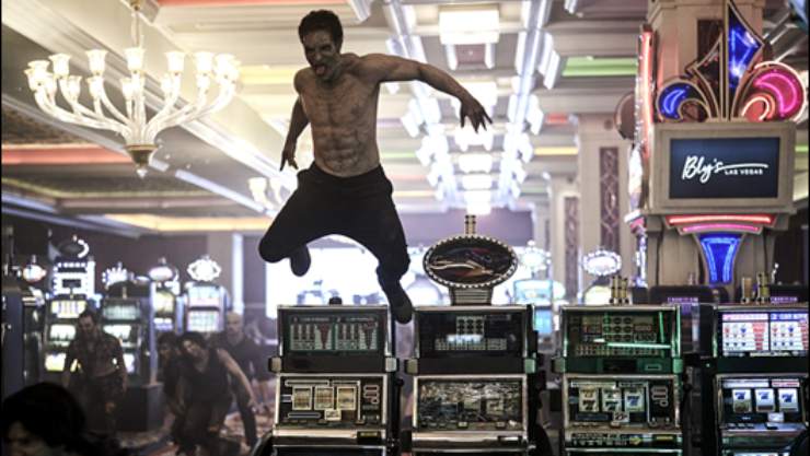 A infected man jumos over a slot machine in a casino
