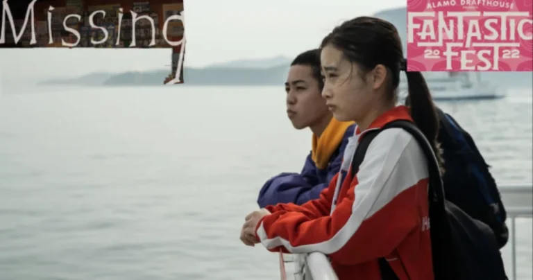 A boy and girl stand over a railing on a boat in Missing (2022)