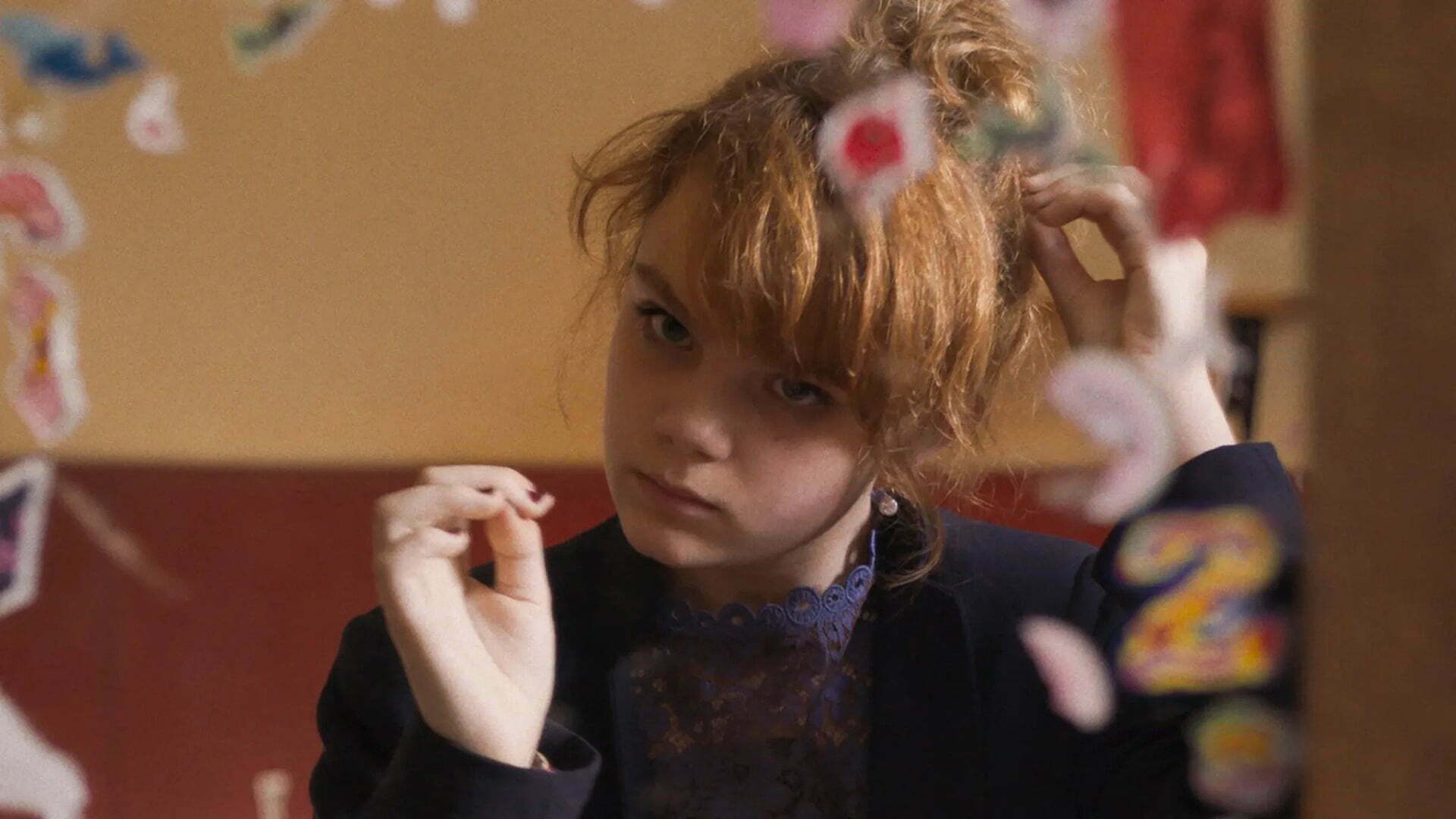 A woman looks at her nails in film Dalva