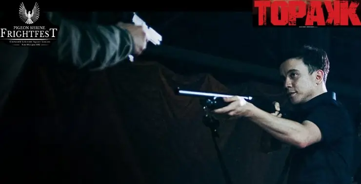 Dark shirt man points a riffle at another man with a gun in Topakk