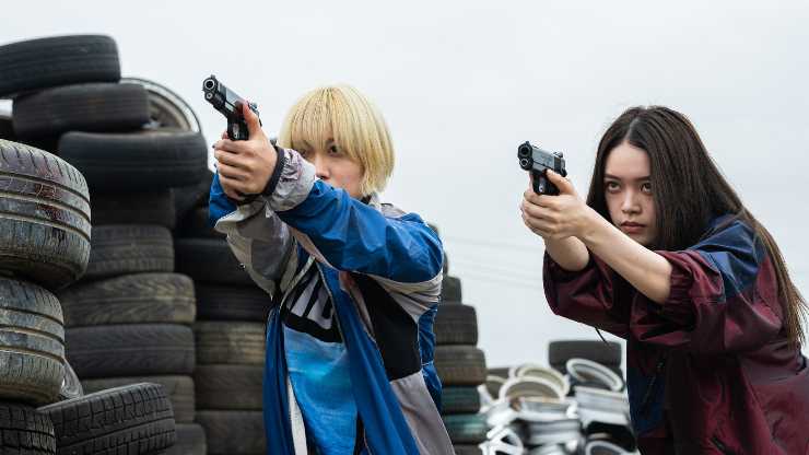 2 Japanese women aim guns at someone in Baby Assassins 2 at Glasgow Film Festival
