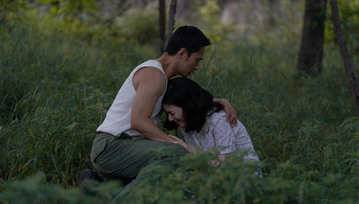 Asian man embracing grieving woman in Pachinko Season 2 coming August 2024