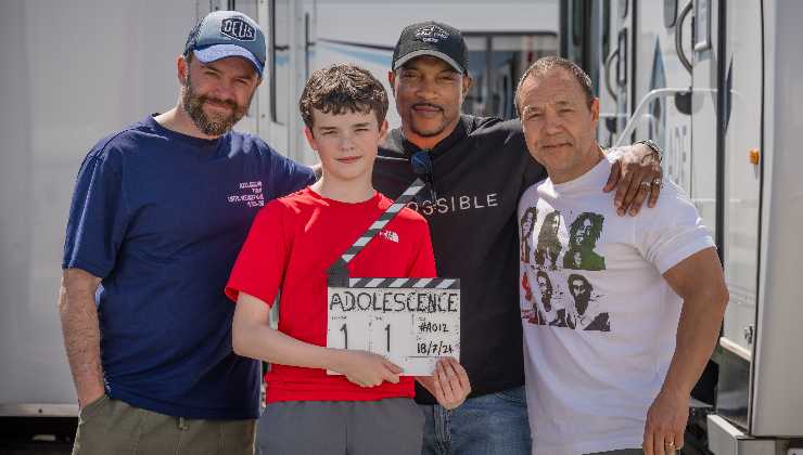 3 men and teen boy stand together for photograph