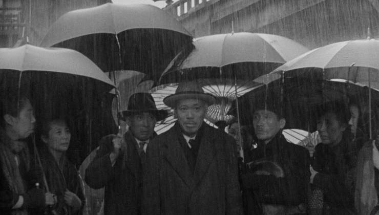 A group of men standing in the rain