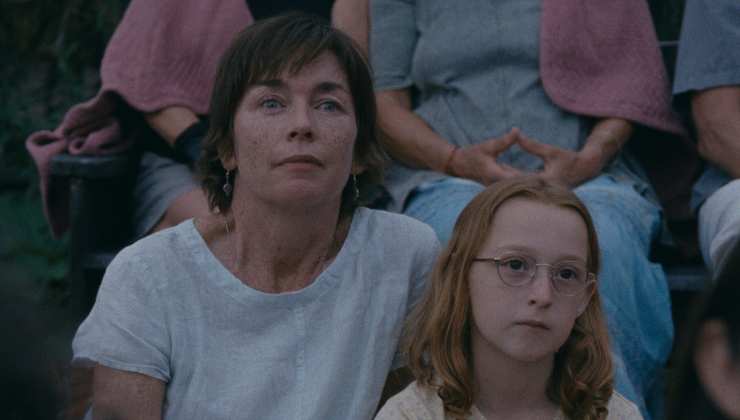 A woman sits with her daughter