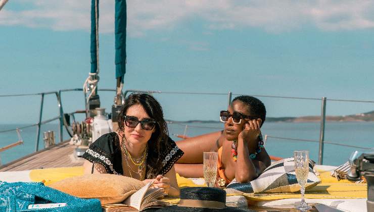 2 women sunbathe on a yacht