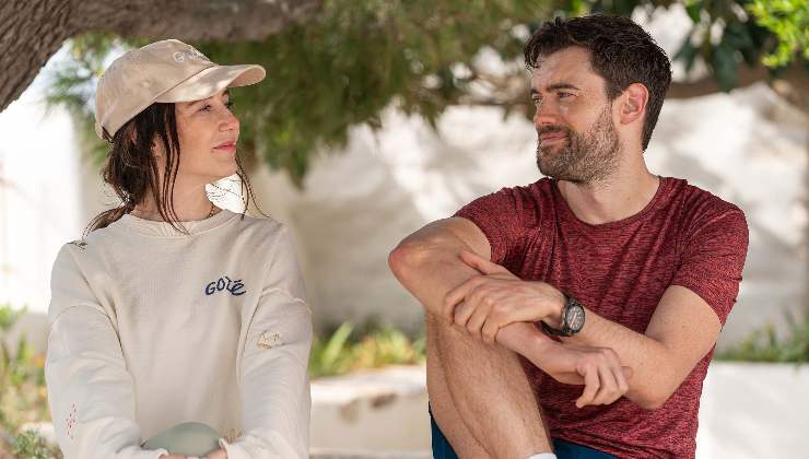 woman in hat mulls what bearded man says to her