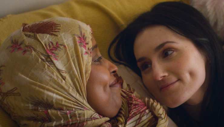 Two women lie down starring at each other