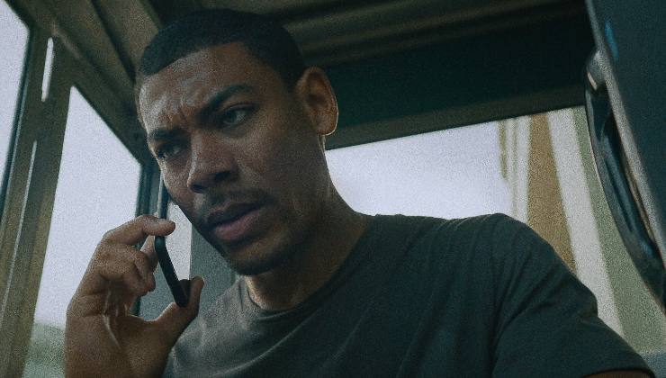 A man desperately tries to call someone on a mobile
