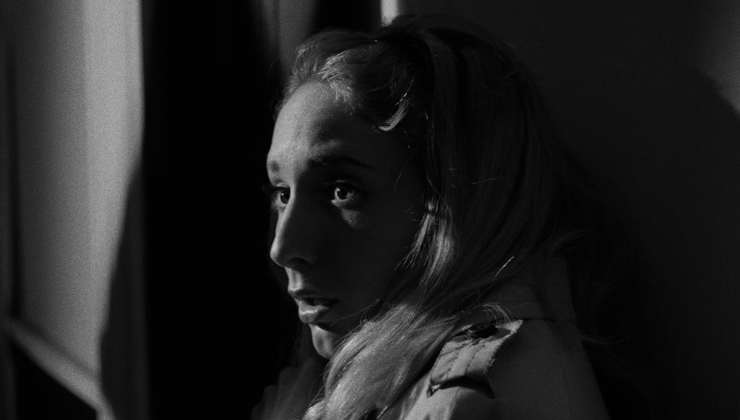 A terrified Young Woman lurks in the dark