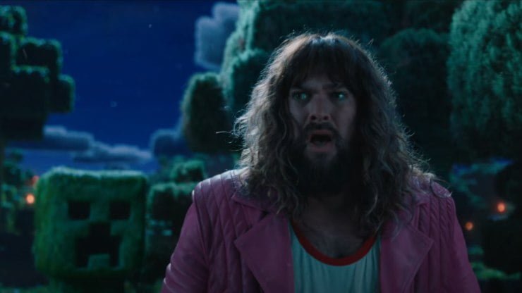 A strange man with a perm and pink jacket on