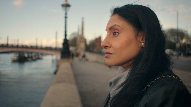 A woman standing by the River in Sweet Bobby