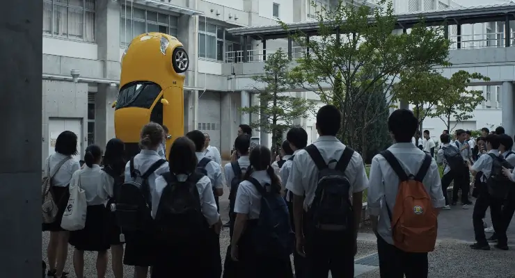 Japanese School teens all stand around a parked car in Happyend