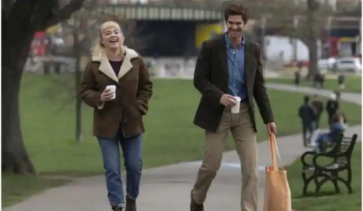 Florence Pugh and Andrew Garfield in We Live In Time have a fun walk through the park
