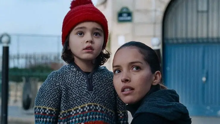 a child and woman look on in An Urban Allegory