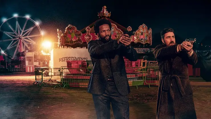 Guns pointed at someone at afair in Gangs Of London Season 3