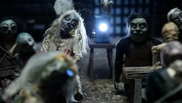 Horror dolls sitting on chairs
