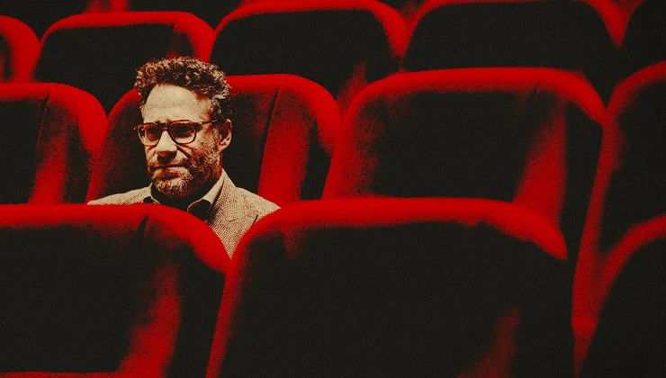 A man sitting in a empty cinema screen
