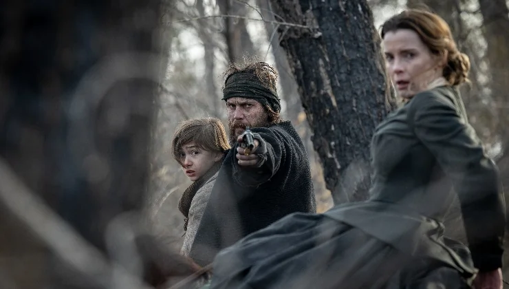 Man with gun with woman and young boy in American Primeval