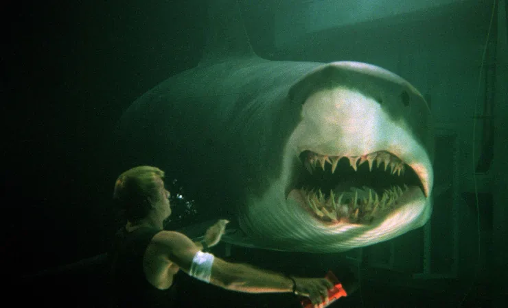 A giant shark stalks a man in Deep Blue Sea