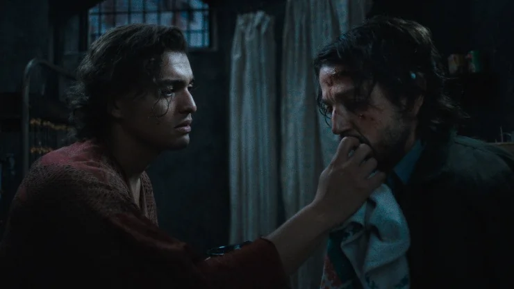 A man wipes another man's mouth in Kiss of the Spider Woman
