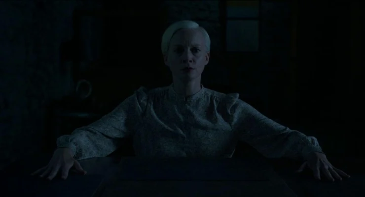 A woman sits in the dark in Oddity