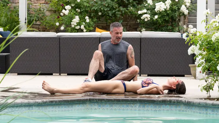 Man in shock of girl dead in front of him in the girl in the pool