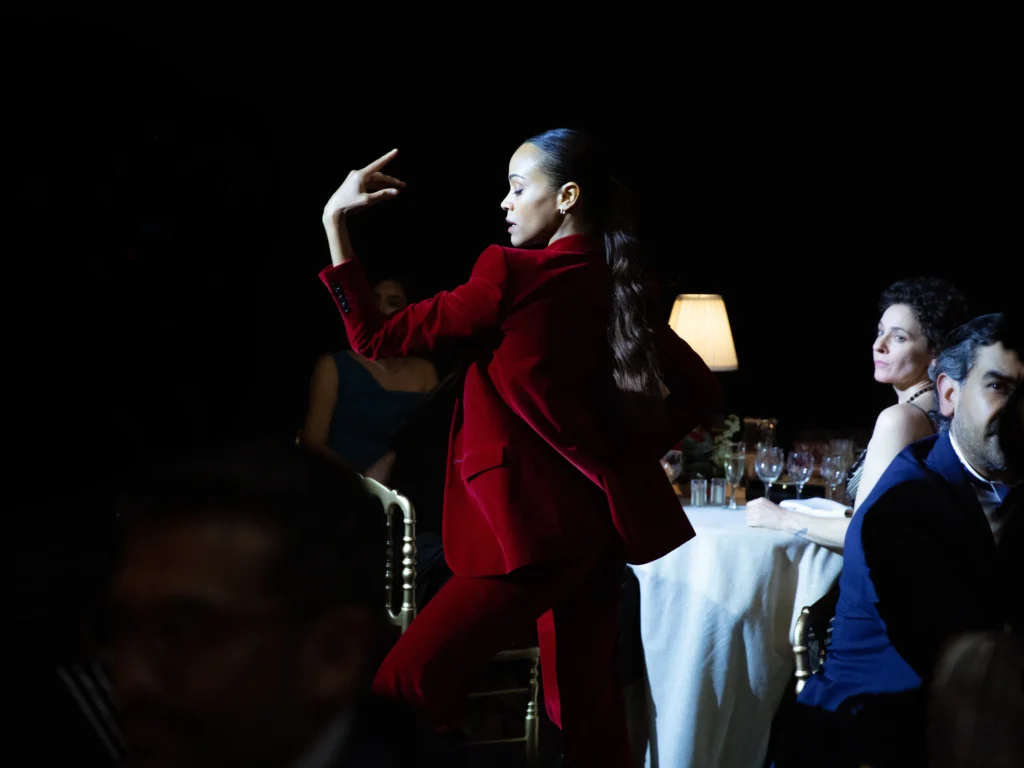 Zoe Saldaña is a Woman dancing and singing in Emilia Perez