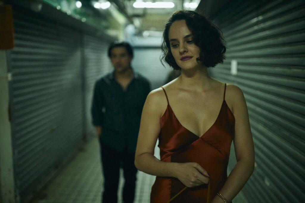 Two people walk through a corridor to find love