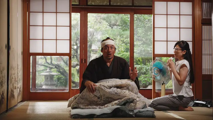 A Japanese sits up in shock after an injury in A Samurai In Time