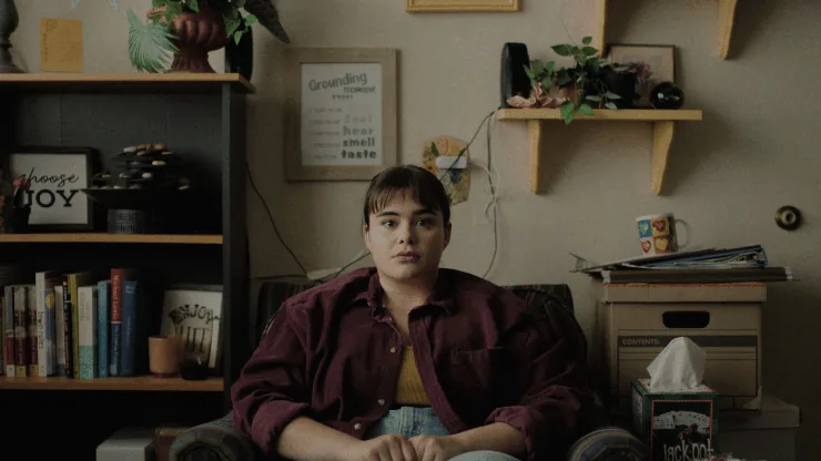 A young woman sits down in Bob Trevino Likes It